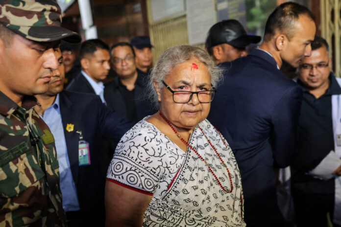Newly sworn-in Nepal’s interim Prime Minister, Sushila Karki arrives at a hospital to meet the victims of Monday’s deadly anti-corruption protests, in Kathmandu